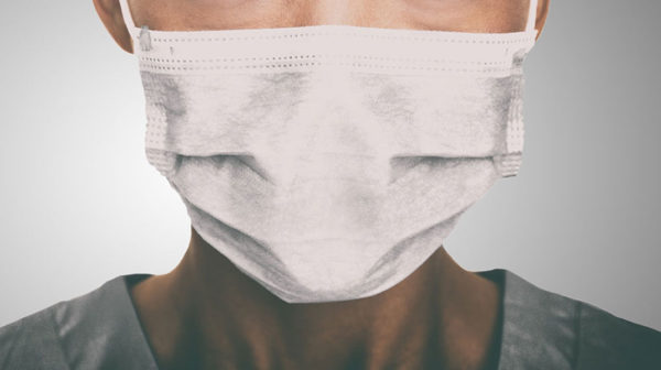 octor wearing protection face mask against coronavirus.